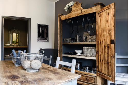 a dining room with a table and a wooden cabinet at Suite11 Como apartment in Como