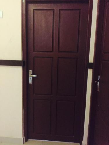 a wooden door in a room with a doorframe at Mega Tourist Home Palarivattom in Cochin