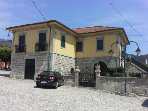 a car parked in front of a house at Casa São João in São João da Serra
