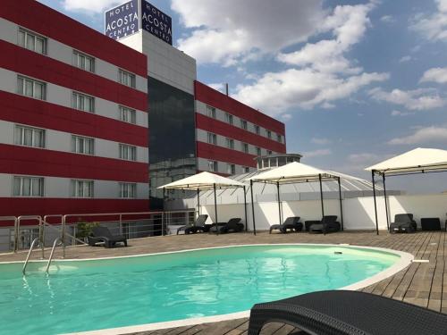 a swimming pool on the roof of a hotel at Hotel Acosta Centro in Almendralejo