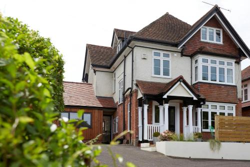 a house with white windows on a street at Lyndhurst House in Lyndhurst