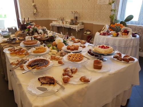 a table with many different types of food on it at Marina Holiday & Spa in Balestrate
