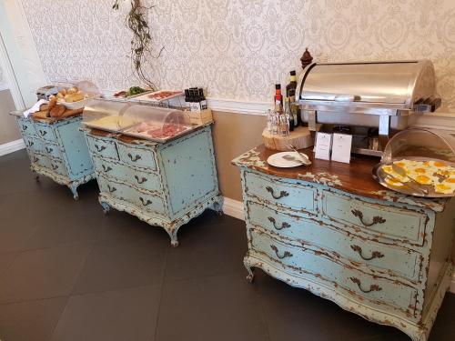 a kitchen with two blue dressers with food on them at Marina Holiday & Spa in Balestrate