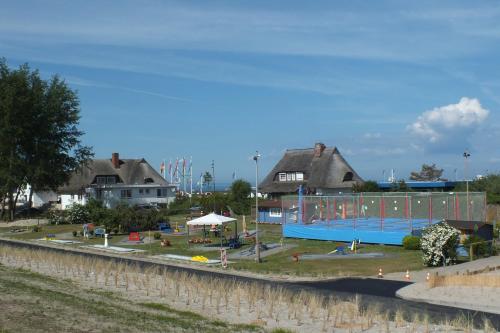 a park with a playground next to a river at Am Deich 51 in Dahme