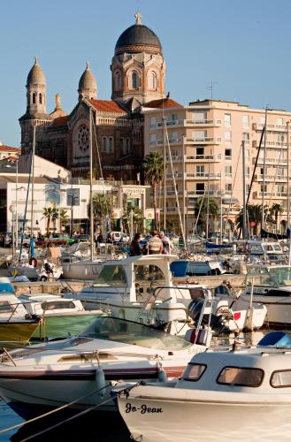 a bunch of boats are parked in a harbor at Hotel Le 21 in Saint-Raphaël