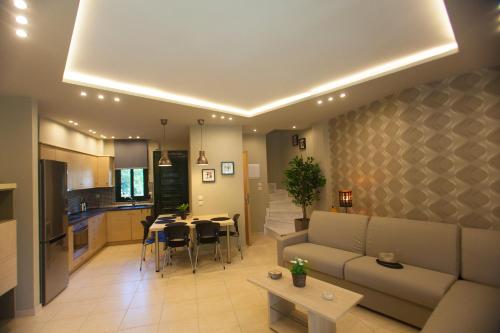 a living room and kitchen with a couch and a table at Mezonetes Toroni in Toroni