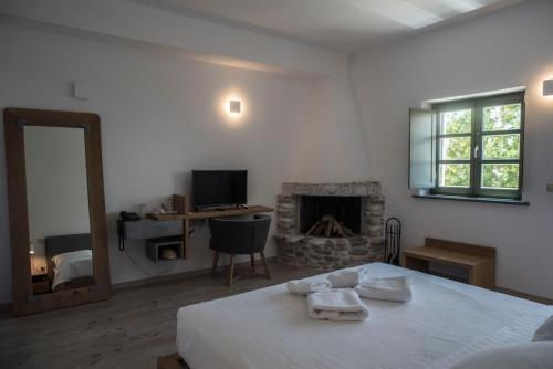 a bedroom with a bed and a fireplace at Alika Resort in Álika