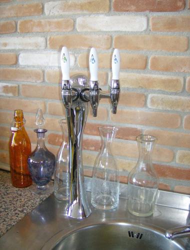 a kitchen sink with glasses and a faucet at Il Grillo Parlante in Monforte dʼAlba