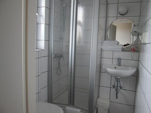 a bathroom with a shower and a sink at Pension Haus Waldfeucht in Waldfeucht