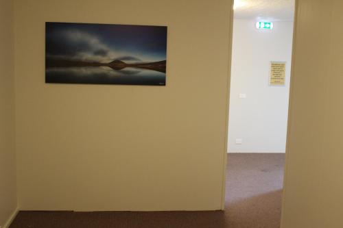 a picture hanging on a wall in a room at North Star Guesthouse Olafsvik in Ólafsvík