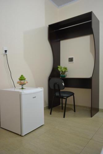a black and white room with a chair and a table at Hotel Consalter in Rodeio Bonito