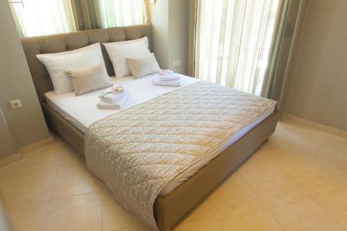 a bedroom with a large bed with two shoes on it at Mezonetes Toroni in Toroni