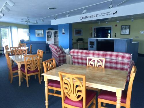 a dining room with a table and chairs at Riverview Resort in South Yarmouth