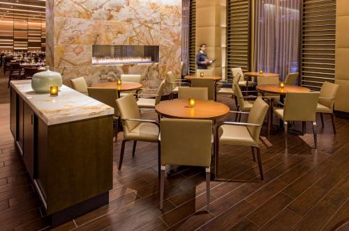a restaurant with tables and chairs and a man in the background at Hyatt Regency Chicago in Chicago