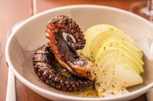 a bowl of food with a pretzel and apple slices at Hyatt Regency Chicago in Chicago