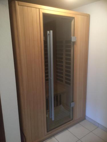 a wooden door with a glass window in a room at Le gîte de la vieille église in Tenneville