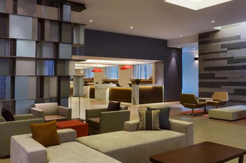 a lobby with couches and chairs and a table at Hyatt Place Shenzhen Dongmen in Shenzhen