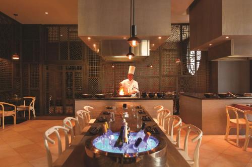 a chef standing in the kitchen of a restaurant at Hyatt Ziva Rose Hall - All Inclusive in Montego Bay
