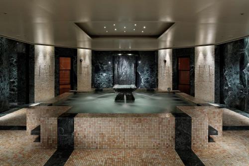 a pool of water in a room with a fountain at Park Hyatt Tokyo in Tokyo