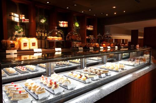 a display case filled with lots of cakes and pastries at Park Hyatt Tokyo in Tokyo