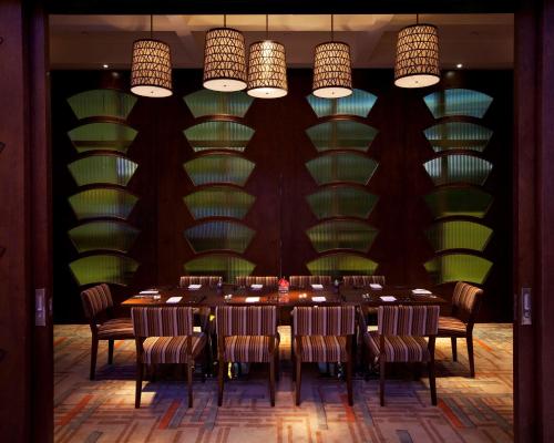a dining room with a long table and chairs at Hyatt Regency Jinan in Jinan