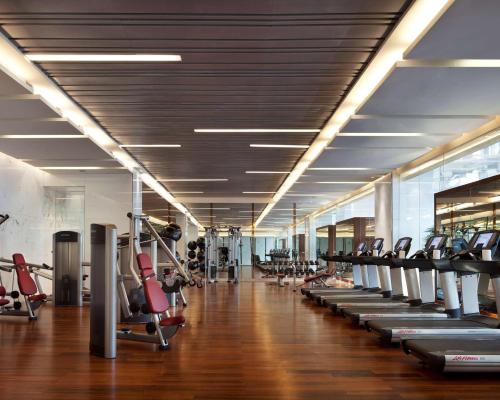 a gym with a row of treadms and cardio machines at Hyatt Regency Jinan in Jinan