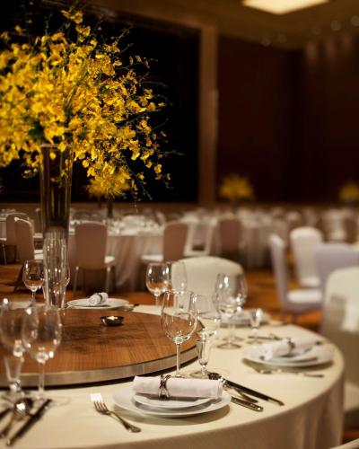 a table with plates and wine glasses on it at Hyatt Regency Jinan in Jinan