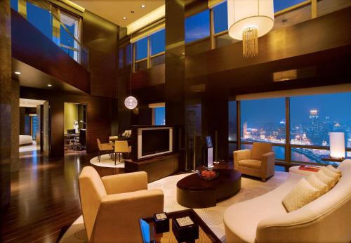a living room with a view of a city at Hyatt on the Bund in Shanghai