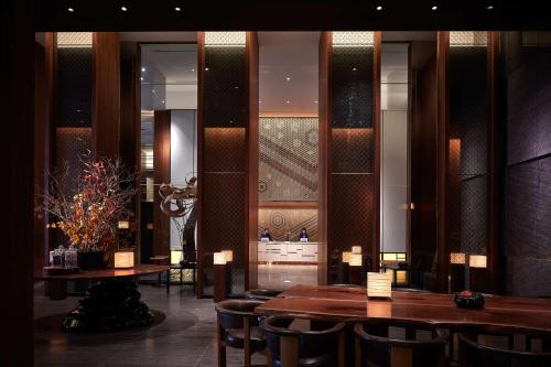 a restaurant with tables and chairs in a room at Andaz Tokyo - A Concept by Hyatt in Tokyo