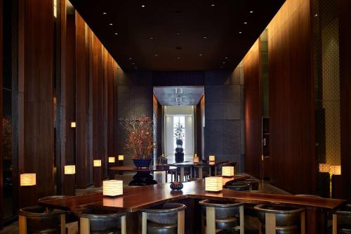 a dining room with chairs and a table and a mirror at Andaz Tokyo - A Concept by Hyatt in Tokyo