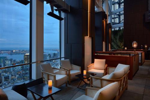 a hotel lobby with chairs and a view of the city at Andaz Tokyo - A Concept by Hyatt in Tokyo