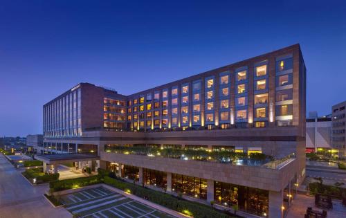 a large building with many windows at night at Hyatt Regency Chandigarh in Chandīgarh