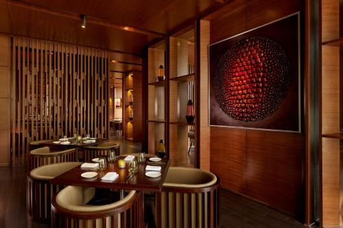 a restaurant with chairs and a table with wine glasses at Hyatt Regency Chandigarh in Chandīgarh
