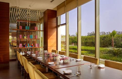 a long dining room with a long table and chairs at Hyatt Regency Chandigarh in Chandīgarh