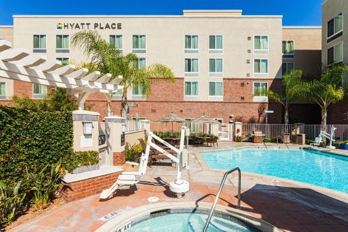 a pool in front of a hotel with a building at Hyatt Place San Diego-Vista/Carlsbad in Vista