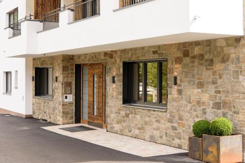 a brick building with a door and windows at AKTIV Apartments in Leutasch