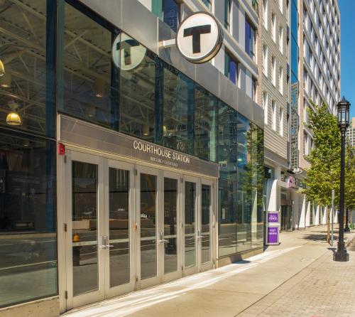 a building with a sign on the side of a street at YOTEL Boston in Boston