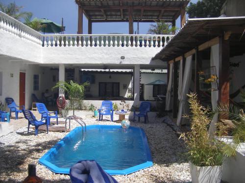 a swimming pool in the backyard of a house at Hostal Palohe Taganga in Taganga