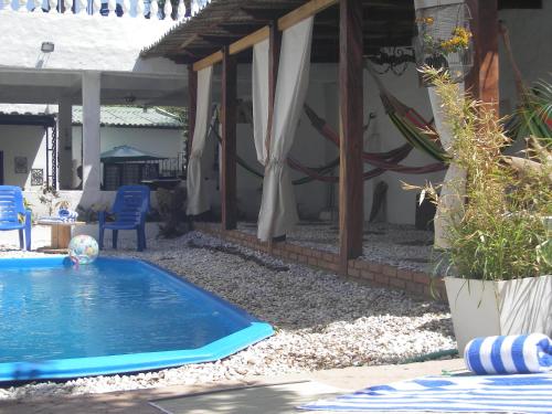 a swimming pool in the yard of a house at Hostal Palohe Taganga in Taganga