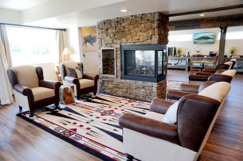 a living room filled with furniture and a fireplace at 1872 Inn - Adults Exclusive in West Yellowstone