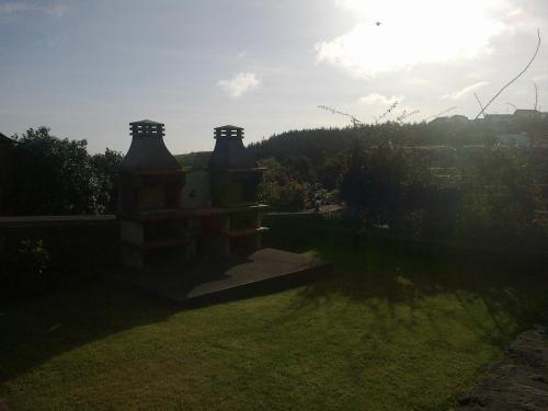 a house with two large towers on a yard at Casas do Monte Alegre in Nordestinho