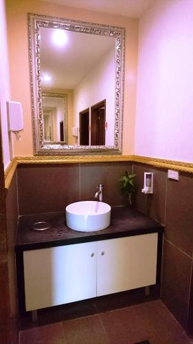 a bathroom with a sink and a mirror at Metropolis Hotel in Taoyuan
