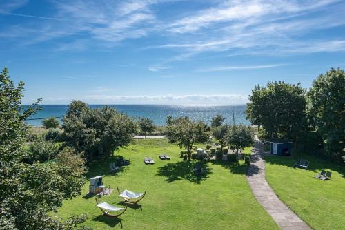 an aerial view of a park with chairs and the ocean at Hotel am Wind in Großenbrode