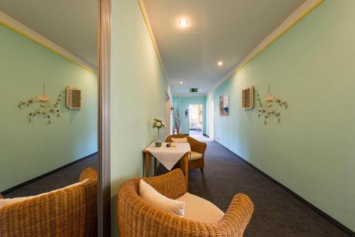 a room with chairs and a table in a room at Hotel am Wind in Großenbrode