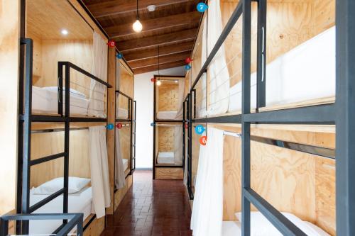 a corridor of a dorm room with bunk beds at Capital Hostel de Ciudad in San José