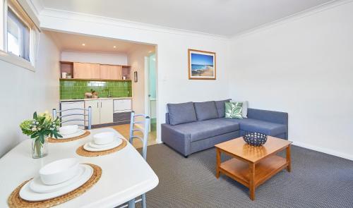 
a living room filled with furniture and a couch at Harbour View Apartments in Ulladulla
