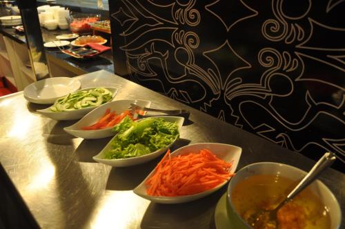 a group of bowls of vegetables on a counter at favehotel MEX Tunjungan Surabaya in Surabaya