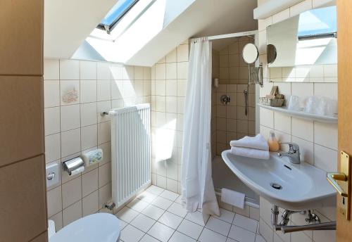 a bathroom with a sink and a shower and a toilet at Landgasthof Hotel Pröll in Eichstätt