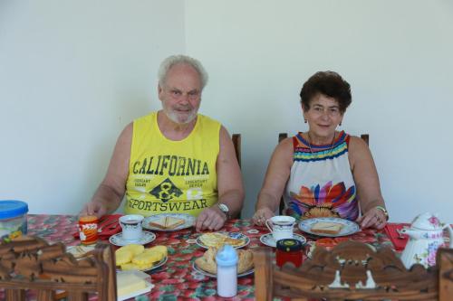 een man en vrouw aan een tafel met eten bij Villa Happy Home in Bentota