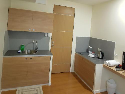 a small kitchen with a sink and a counter at The Leaf House in Manila